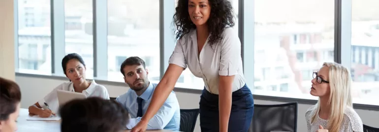 Person leads a meeting in a modern office setting.