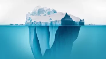 Large iceberg floating with most hidden underwater.